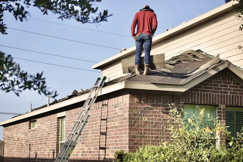 Professional roofer working on a residential roof in La Junta